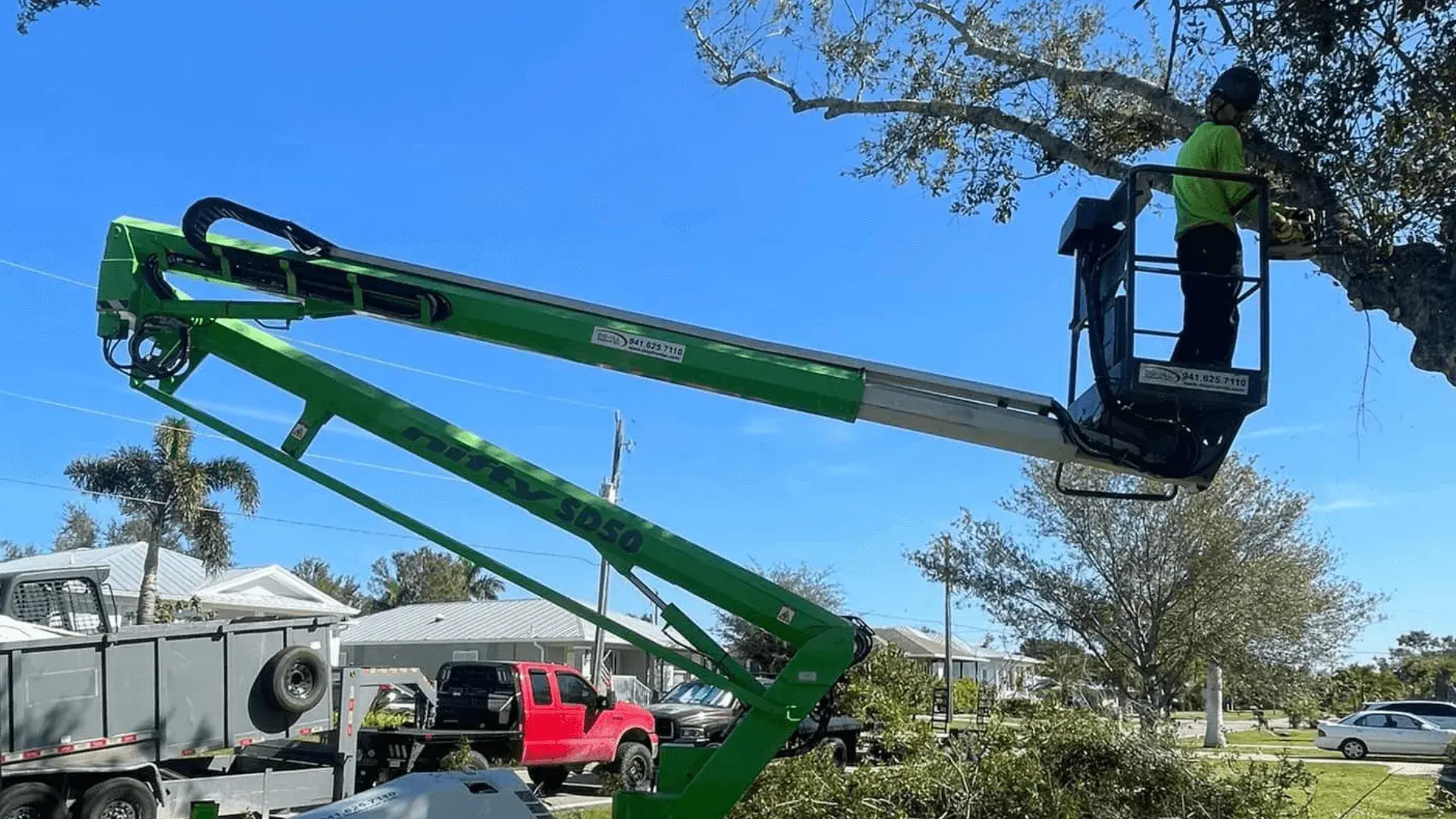 Professional tree removal with bucket lift in Port Charlotte